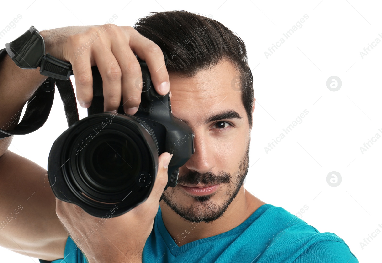 Photo of Young professional photographer taking picture on white background