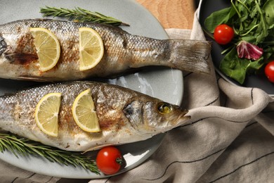 Delicious baked fish served on table, top view