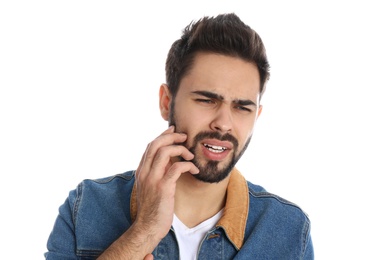 Man suffering from toothache on white background