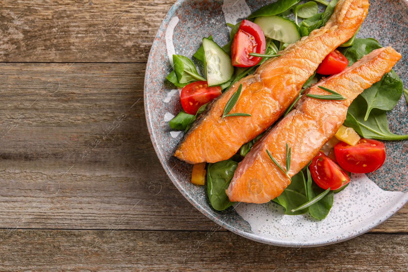 Photo of Healthy meal. Tasty grilled salmon with vegetables and spinach on wooden table, top view. Space for text