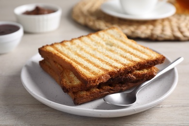 Photo of Tasty toasts served for breakfast on white wooden table, closeup