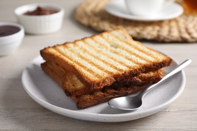 Tasty toasts served for breakfast on white wooden table, closeup