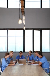 Photo of Medical students in uniforms studying at university