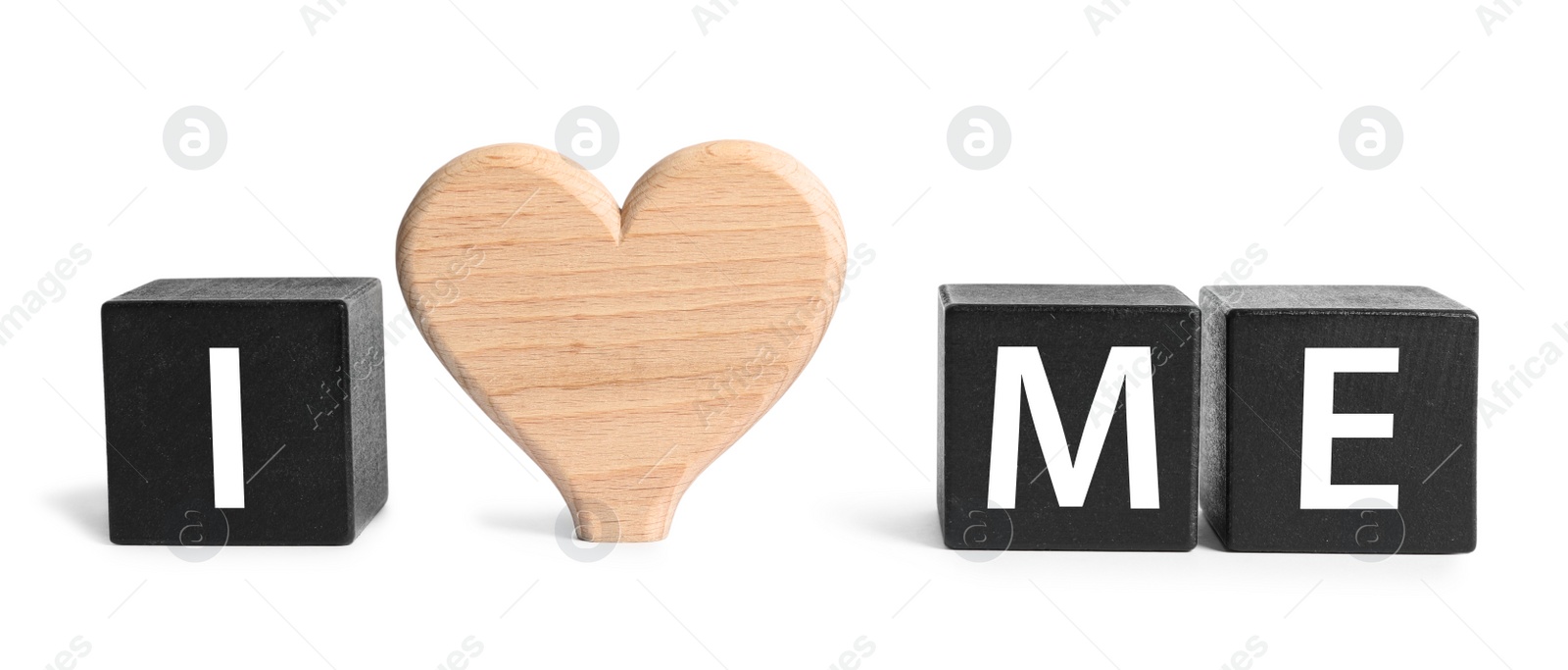 Photo of Phrase I Love Me made with black cubes and wooden heart on white background