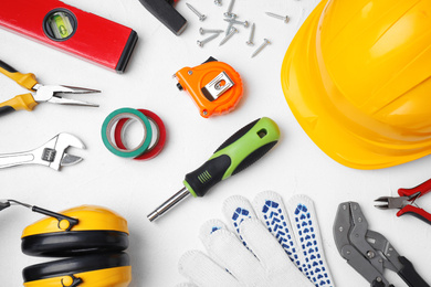 Photo of Flat lay composition with construction tools on white background
