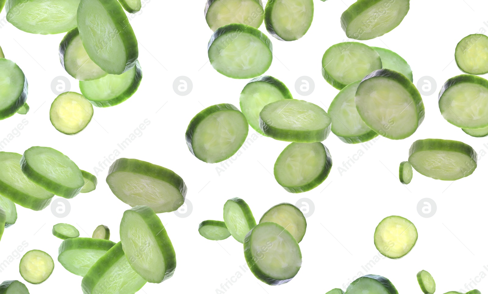 Image of Slices of fresh green cucumbers falling on white background