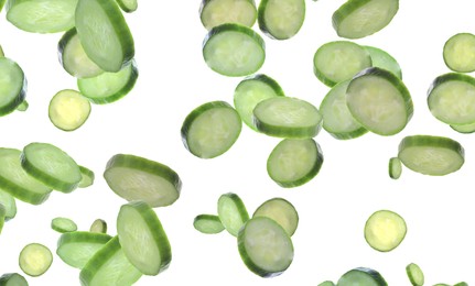 Slices of fresh green cucumbers falling on white background