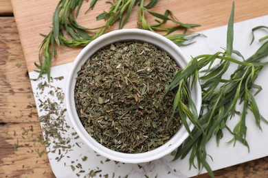 Photo of Dry and fresh tarragon on table, top view