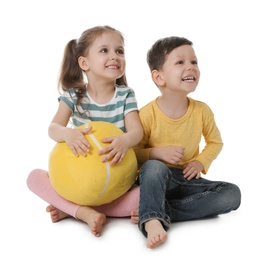 Photo of Cute little boy and girl with soft ball on white background