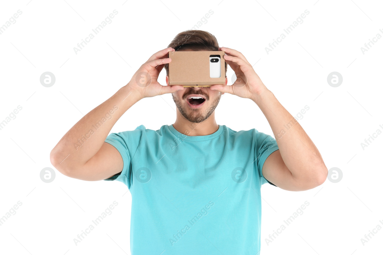 Photo of Young man using cardboard virtual reality headset, isolated on white