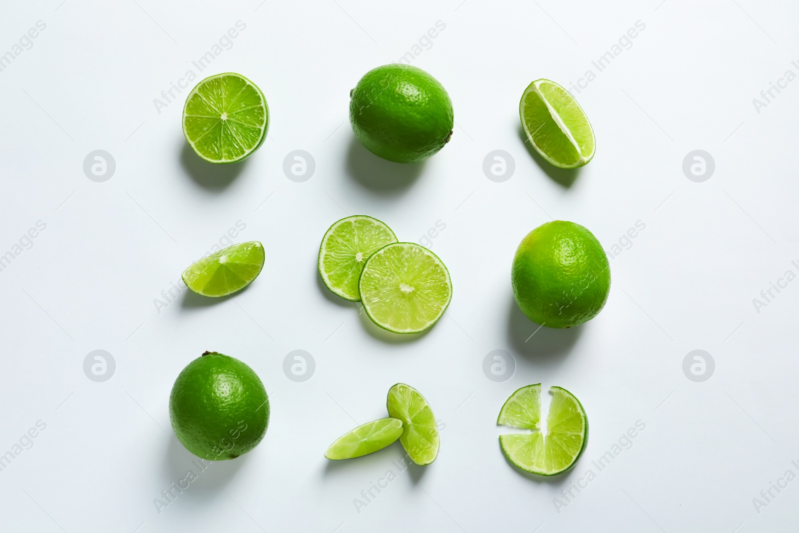 Photo of Fresh ripe green limes on white background