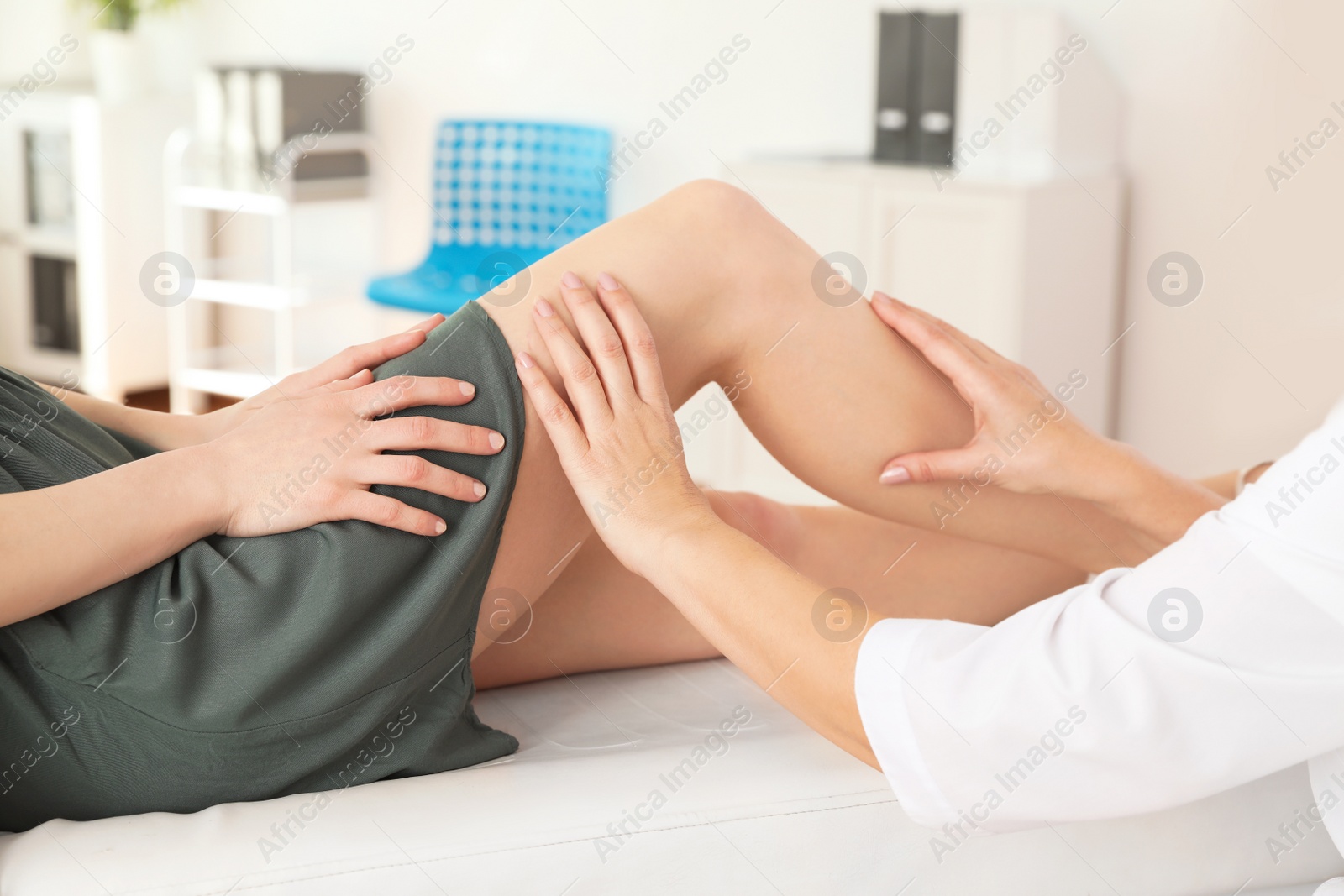 Photo of Doctor examining patient with knee problems in clinic, closeup