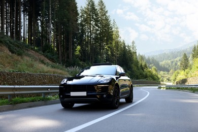Picturesque view of asphalt road with modern black car outdoors