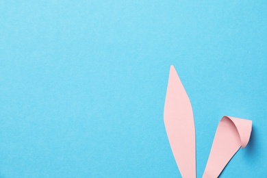 Funny Easter bunny ears on color background, top view with space for text