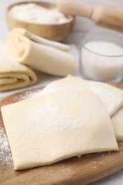 Raw puff pastry dough on table, closeup