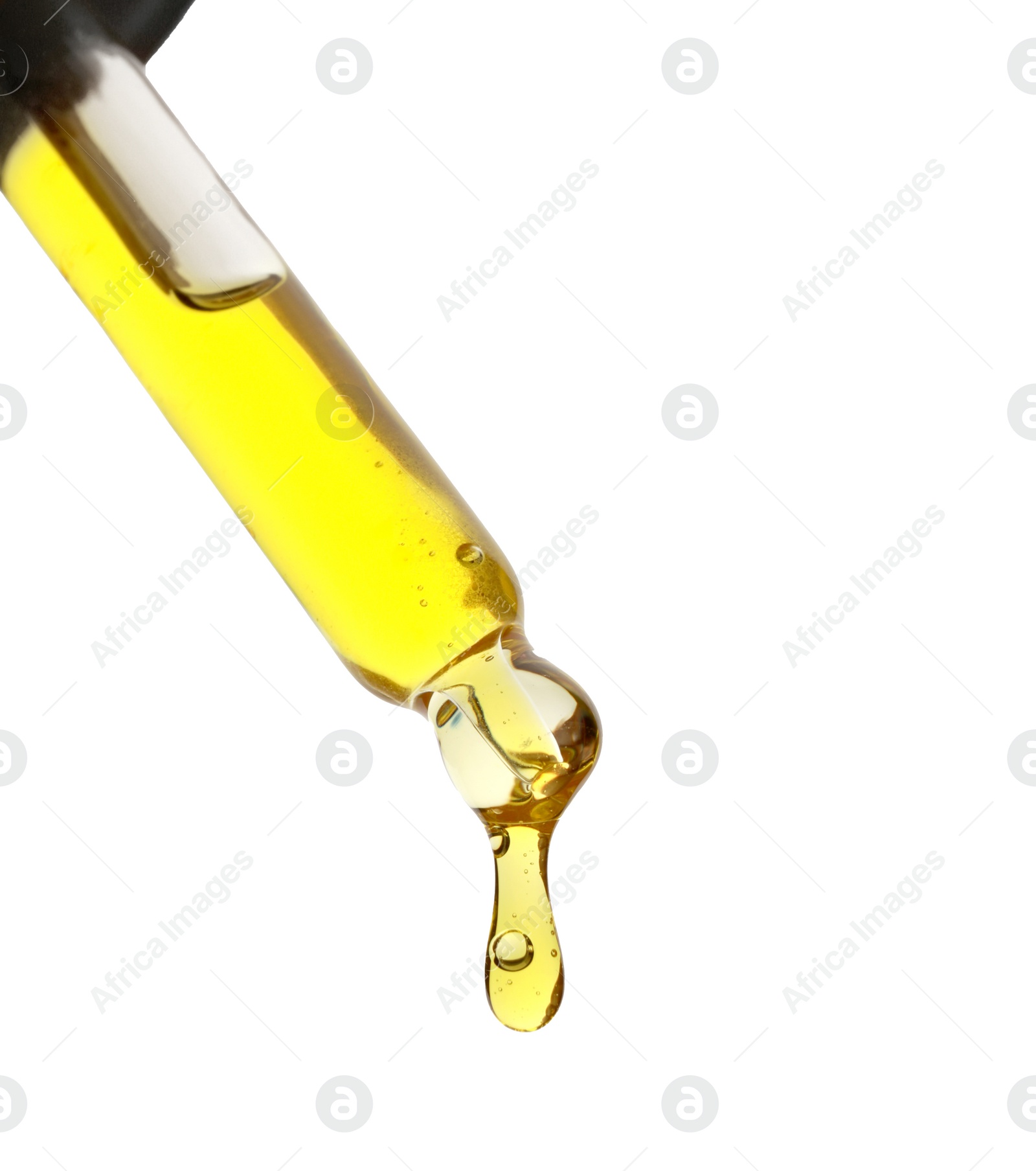 Photo of Dripping yellow facial serum from pipette on white background, closeup