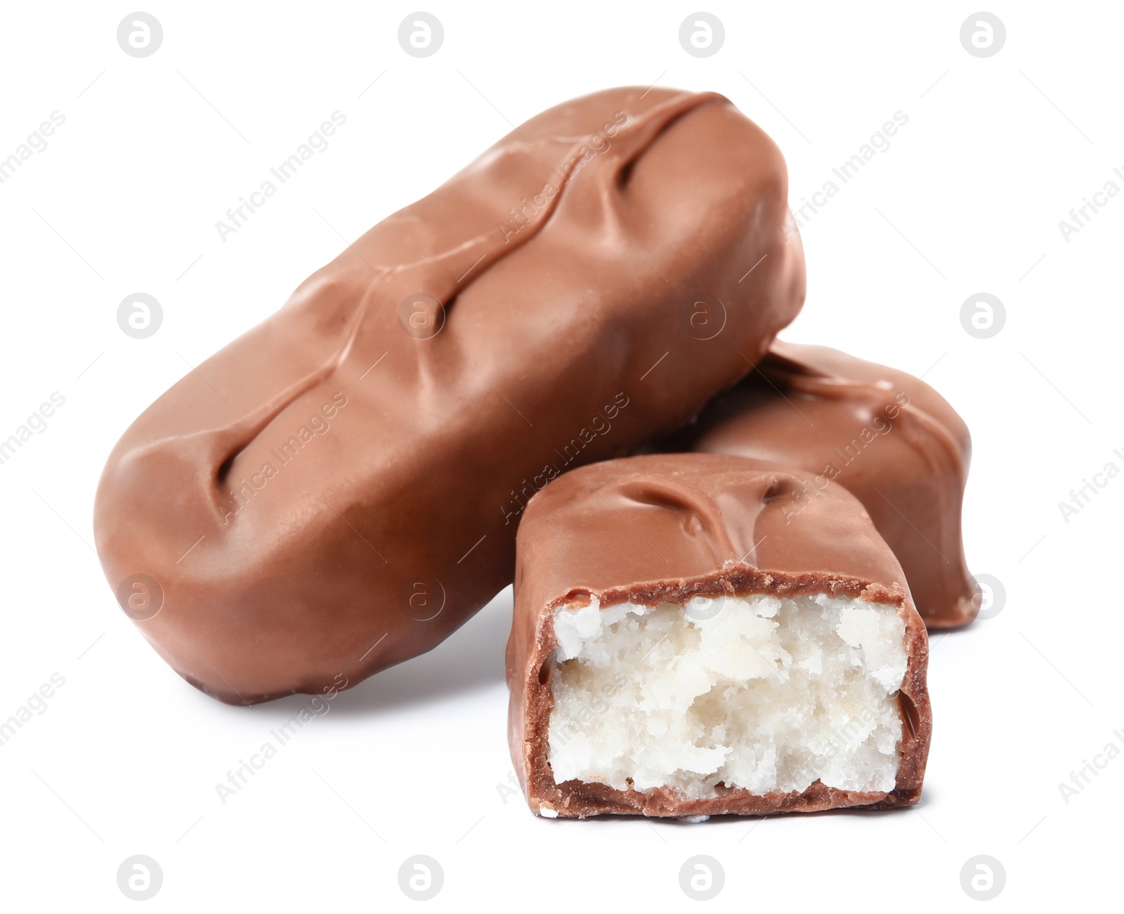 Photo of Delicious milk chocolate candy bars with coconut filling on white background