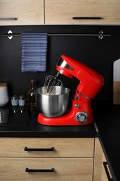 Photo of Modern stand mixer on countertop in kitchen. Home appliance