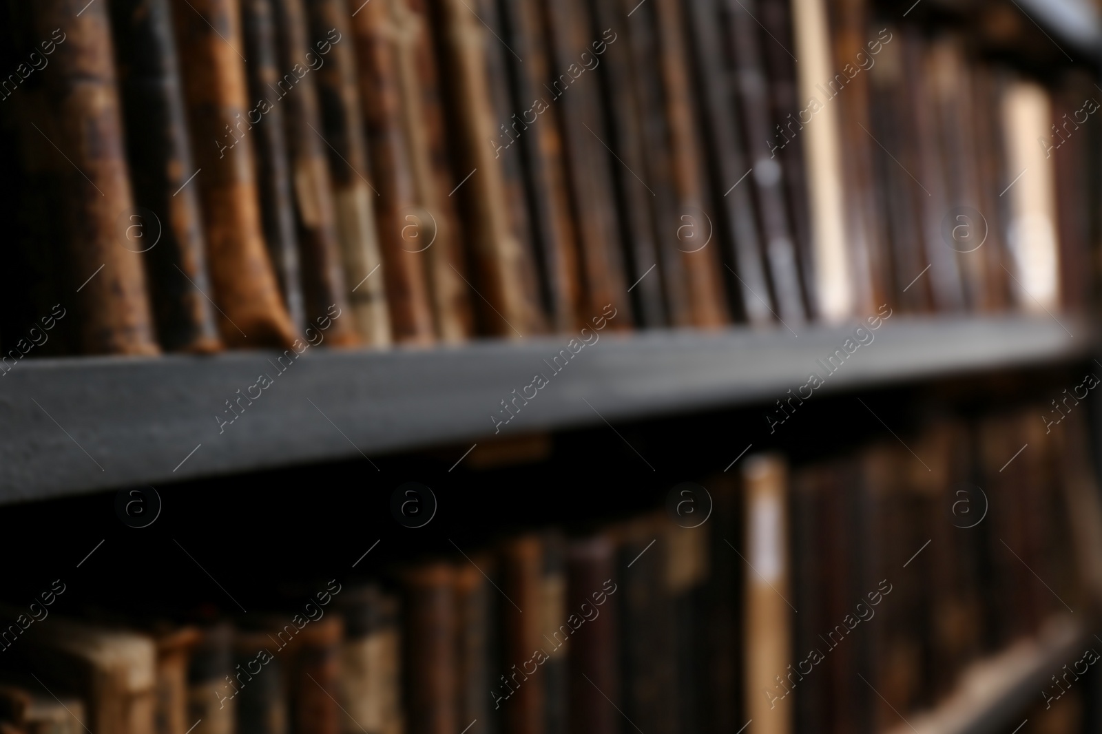 Photo of Blurred view of different books on shelves in library