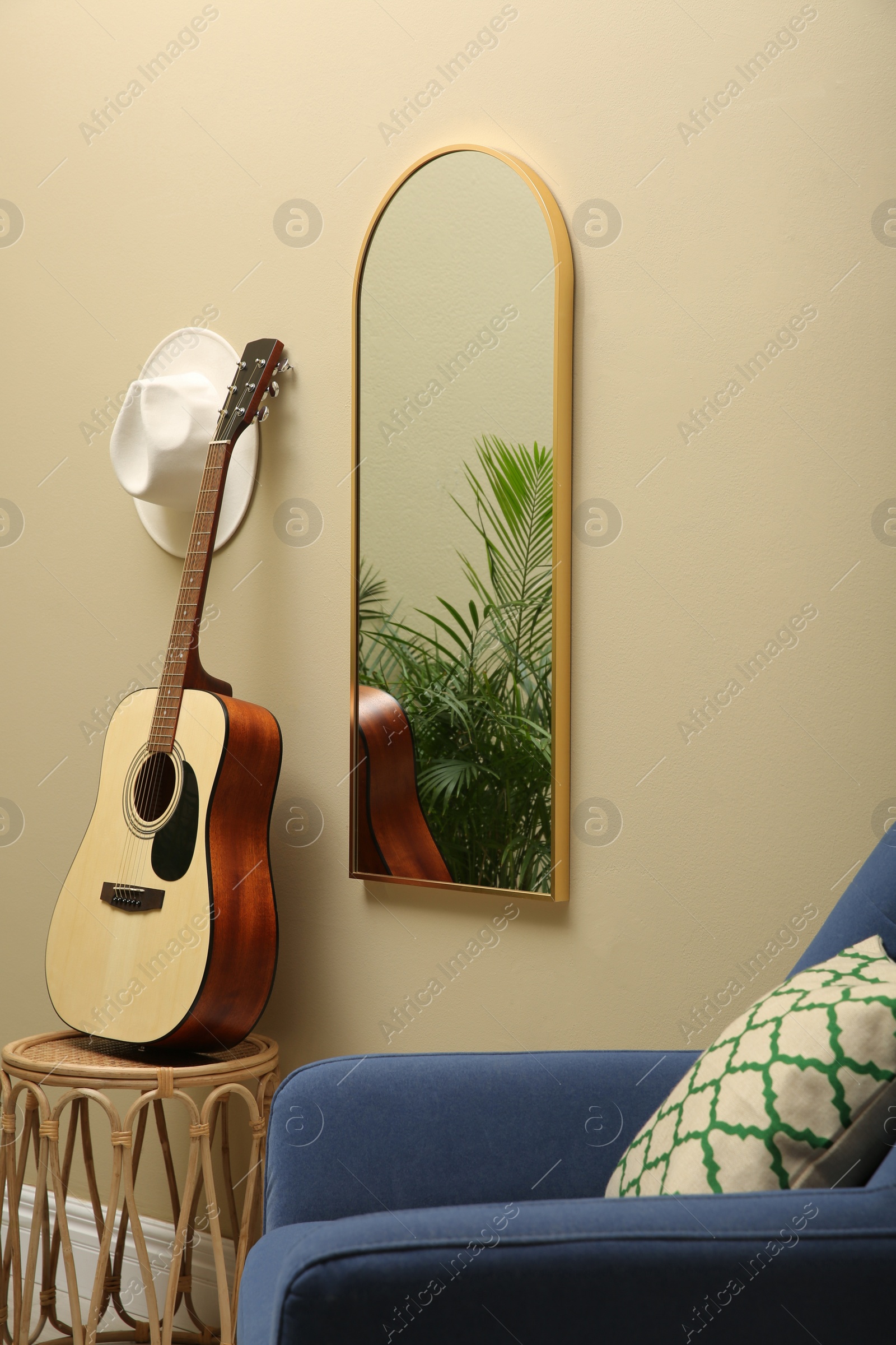 Photo of Living room interior with mirror on beige wall. Stylish accessories