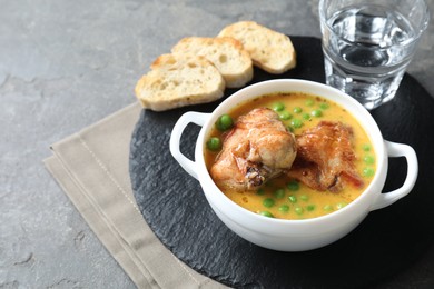 Photo of Tasty cooked rabbit meat with sauce served on grey table. Space for text