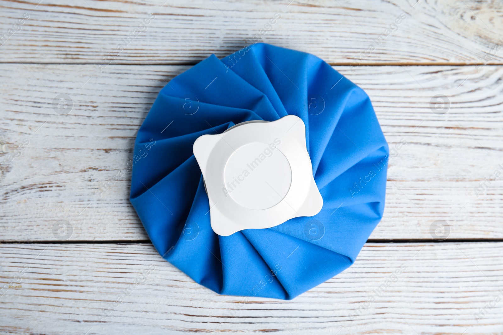 Photo of Ice pack on white wooden table, top view