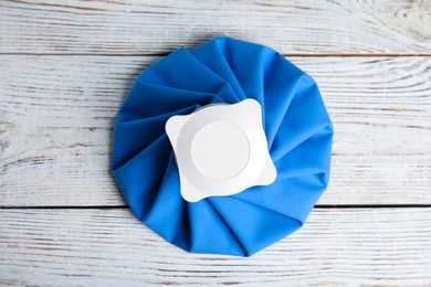 Photo of Ice pack on white wooden table, top view