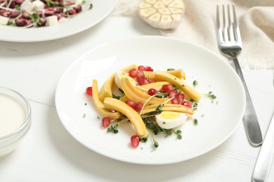 Photo of Delicious fresh carrot salad served on white wooden table, closeup