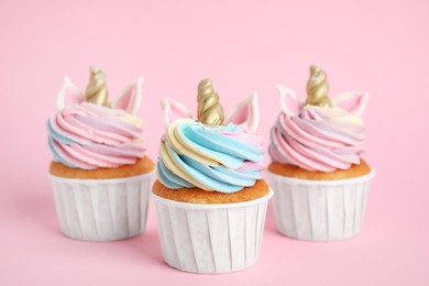 Photo of Cute sweet unicorn cupcakes on pink background