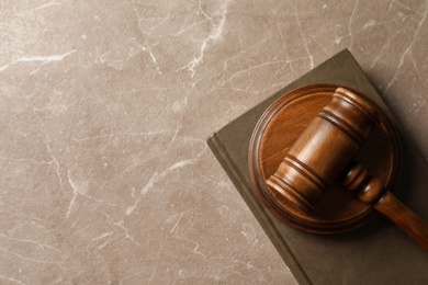 Wooden gavel and book on table, top view. Law concept