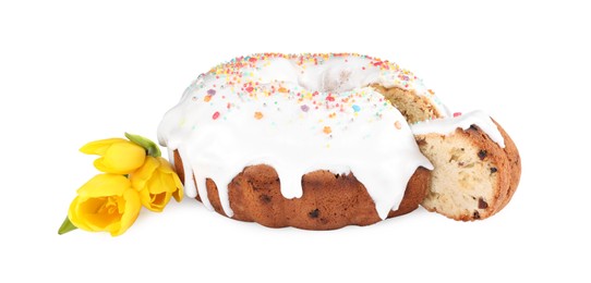 Photo of Traditional Easter cake with sprinkles and yellow tulips on white background