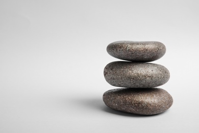 Stacked zen stones on white background. Space for text