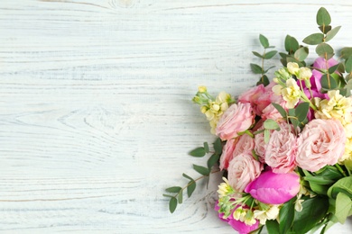 Photo of Bouquet of beautiful fragrant flowers on wooden background