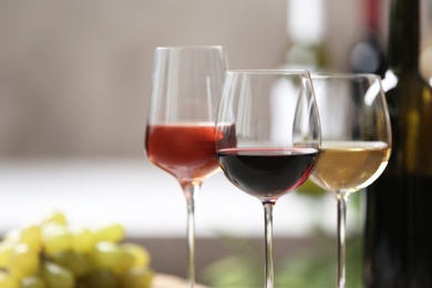 Photo of Different glasses with wine served on table