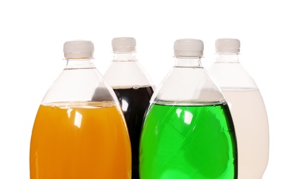 Bottles of soft drinks on white background, closeup