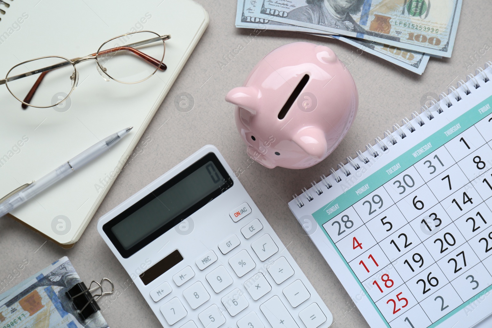 Photo of Flat lay composition with piggy bank and calculator on light grey background