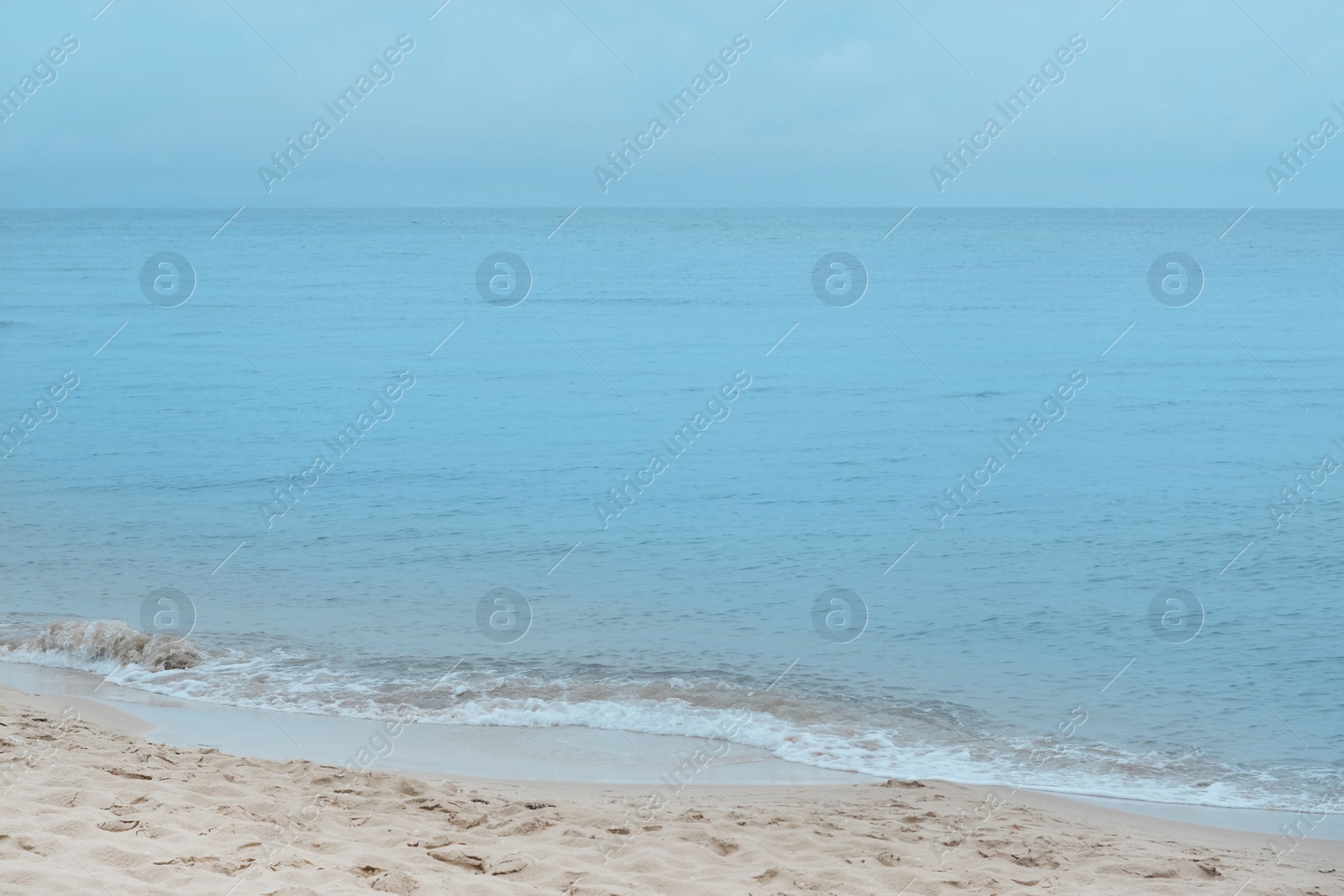 Photo of Picturesque view of beautiful sea waves on sandy beach
