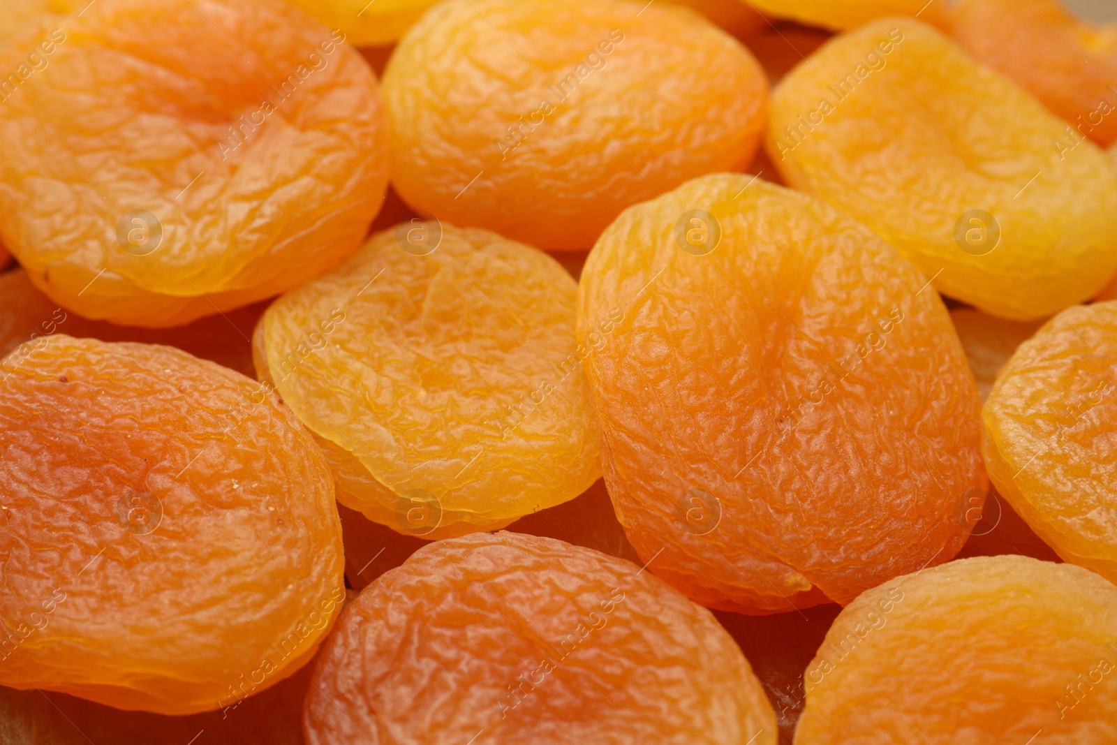 Photo of Tasty dried apricots as background, closeup. Healthy snack