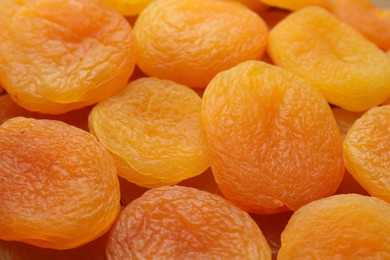 Tasty dried apricots as background, closeup. Healthy snack