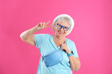 Photo of Portrait of cool grandmother on color background