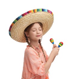 Photo of Cute girl in Mexican sombrero hat dancing with maracas on white background