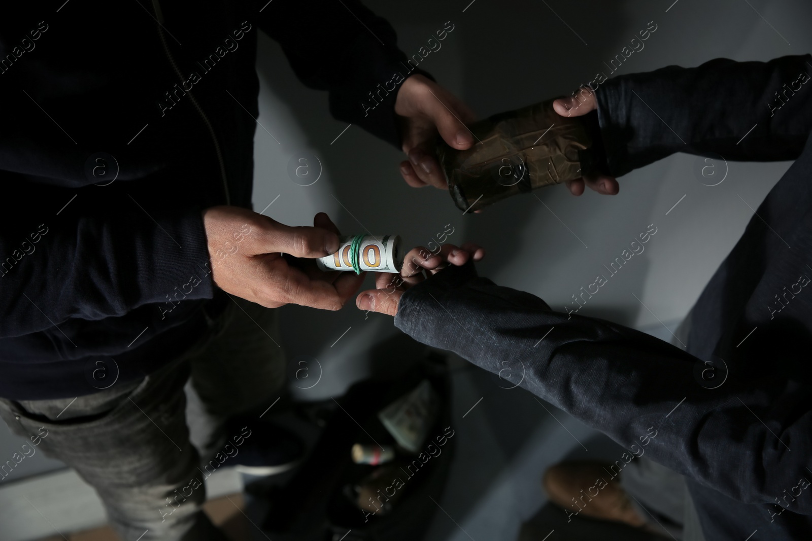 Photo of Addicted man buying drugs from dealer, focus on hands