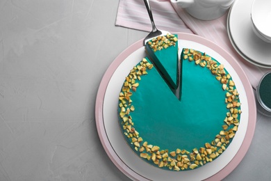 Photo of Flat lay composition with tasty spirulina cheesecake on grey table, space for text