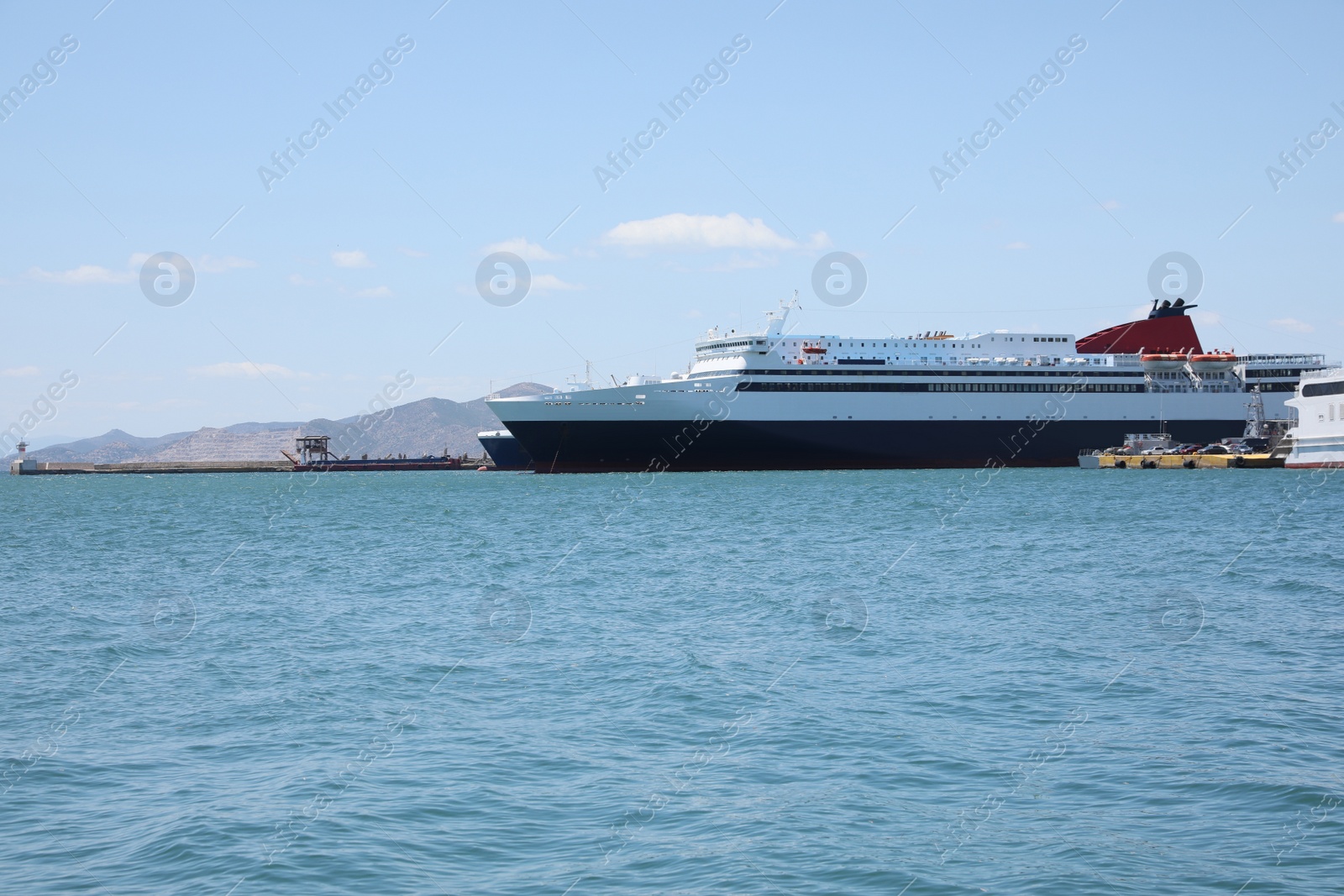 Photo of Modern ferry in sea port on sunny day