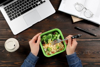 Photo of Office employee having business lunch at workplace, top view