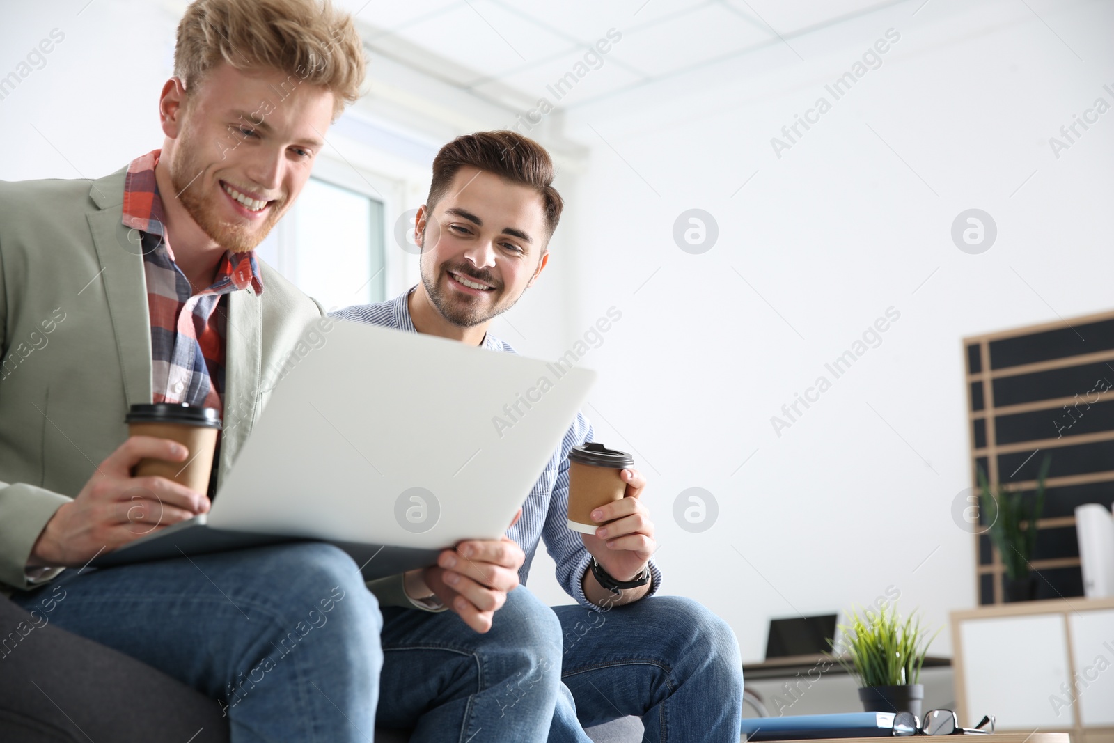 Photo of Business people working on laptop in office, space for text. Professional communication