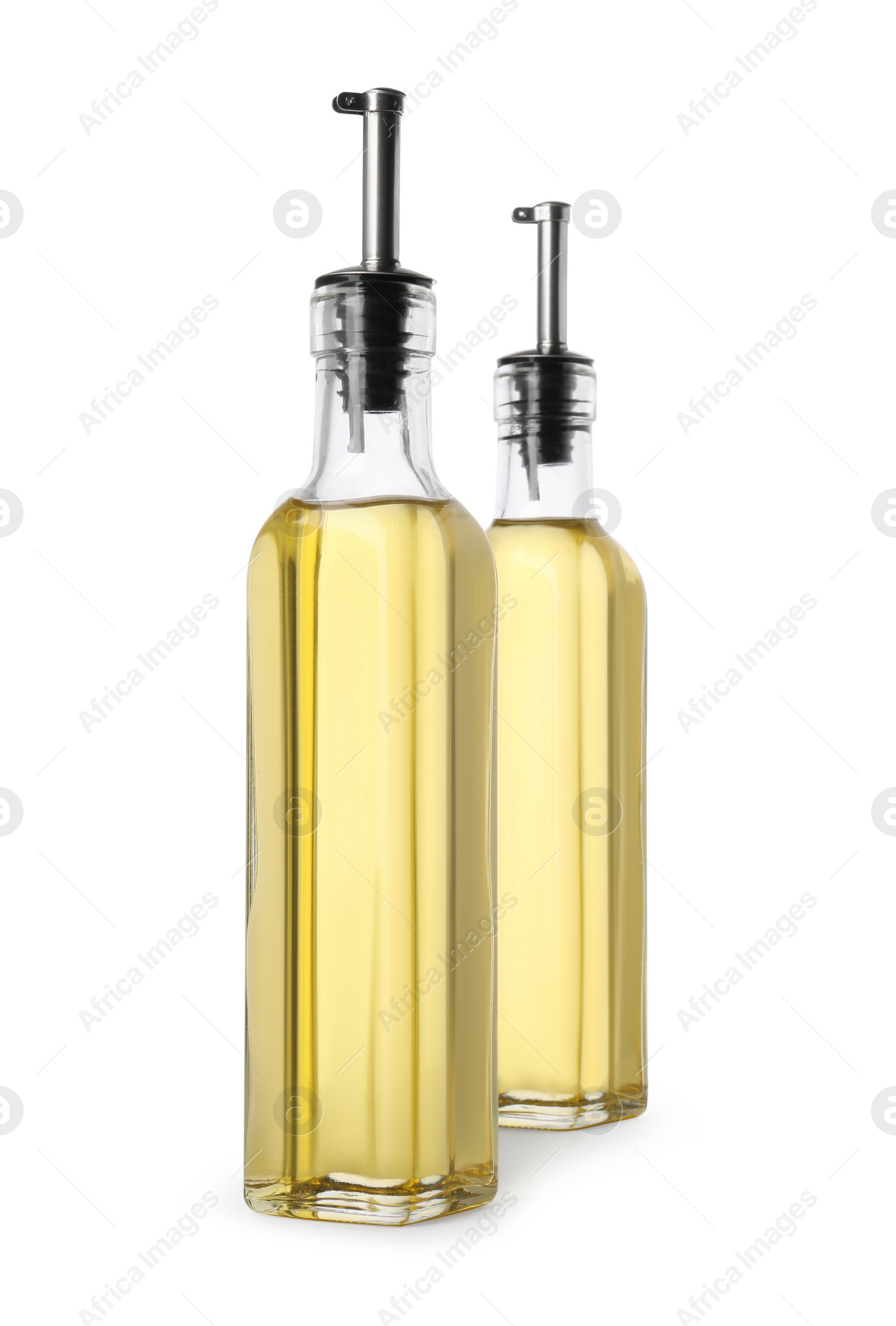 Photo of Glass bottles of cooking oil on white background