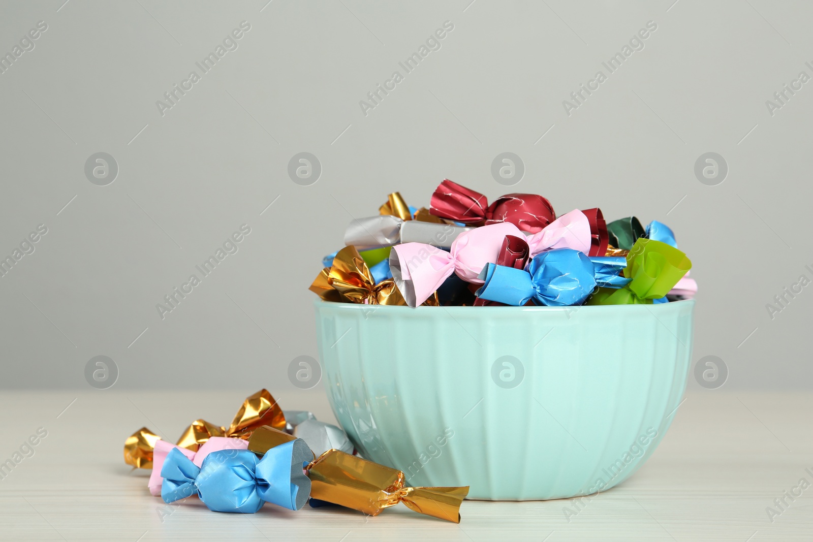 Photo of Candies in colorful wrappers on light table