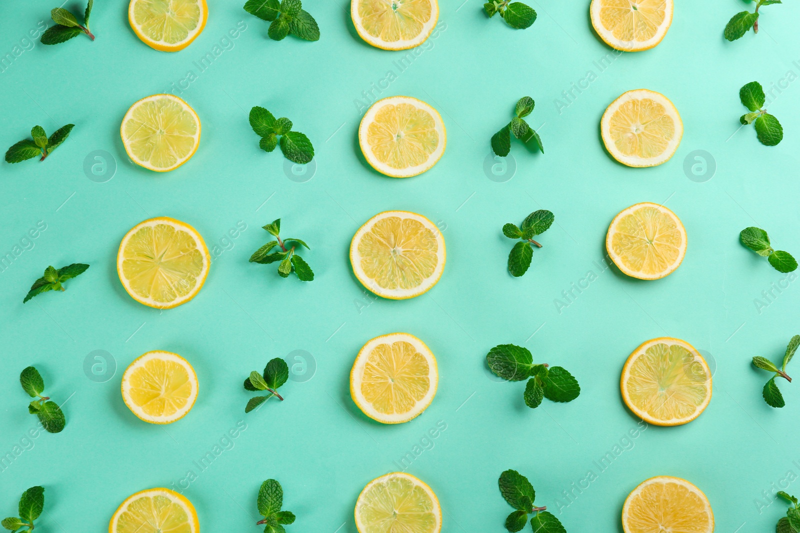 Photo of Lemonade layout with juicy lemon slices and mint on turquoise background, top view