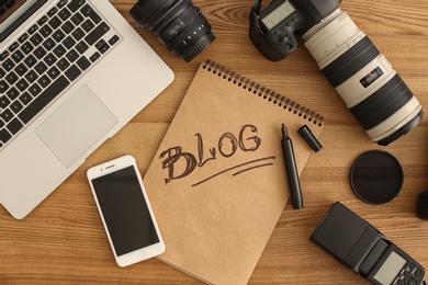 Flat lay composition with different blogger equipment on wooden background